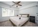 Bedroom with a bed, dark wood nightstand, ceiling fan, and natural light at 1105 Gun Club Nw Rd, Atlanta, GA 30318