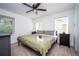 A primary bedroom has natural light with matching dressers and neutral decor at 1105 Gun Club Nw Rd, Atlanta, GA 30318