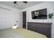 Bedroom with a large TV, dresser, bed, linens, and closet access at 1105 Gun Club Nw Rd, Atlanta, GA 30318