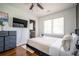 Bright bedroom with hardwood floors, a ceiling fan, a double window, and ensuite bathroom at 1105 Gun Club Nw Rd, Atlanta, GA 30318
