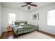 Cozy bedroom with green linens, hardwood floors, a ceiling fan and natural light at 1105 Gun Club Nw Rd, Atlanta, GA 30318