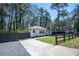 Charming home featuring a well-maintained lawn, a classic brick exterior, and a long driveway at 1105 Gun Club Nw Rd, Atlanta, GA 30318