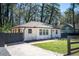 Charming white brick home with a well-manicured lawn and a paved driveway at 1105 Gun Club Nw Rd, Atlanta, GA 30318