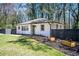 Well-maintained home with lush landscaping, a green door, and a black fence at 1105 Gun Club Nw Rd, Atlanta, GA 30318