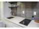 Modern kitchen is designed with white marble countertops and sleek electric stovetop at 1105 Gun Club Nw Rd, Atlanta, GA 30318