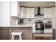 Modern kitchen featuring sleek white cabinets, granite countertops, and stainless steel appliances at 1105 Gun Club Nw Rd, Atlanta, GA 30318