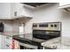 A close-up of a modern kitchen featuring granite countertops, stainless steel appliances, and white cabinets at 1105 Gun Club Nw Rd, Atlanta, GA 30318