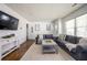 Bright living room featuring hardwood floors, neutral paint, two sofas, and natural light at 1105 Gun Club Nw Rd, Atlanta, GA 30318