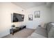 Inviting living room with comfortable gray sofa, wall art, and mounted TV at 1105 Gun Club Nw Rd, Atlanta, GA 30318