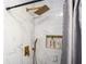 Elegant tiled shower with gold hardware, rainfall shower head, and niche for toiletries at 1105 Gun Club Nw Rd, Atlanta, GA 30318