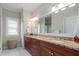 Bathroom with double sink vanity, granite countertop, and large mirror at 1810 Annie Nw St, Atlanta, GA 30318