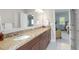 Bright bathroom with double sinks, granite countertop, and access to bedroom at 1810 Annie Nw St, Atlanta, GA 30318