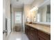 Bathroom with tiled floor, a granite vanity, a shower, and a window at 1810 Annie Nw St, Atlanta, GA 30318