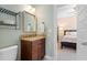 Bathroom vanity features granite counters and a dark wood cabinet with a bedroom view at 1810 Annie Nw St, Atlanta, GA 30318