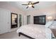Bedroom with adjoining bathroom, large dark cabinet, and ceiling fan at 1810 Annie Nw St, Atlanta, GA 30318