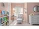 Charming bedroom with soft colors, decorative shelving, and comfortable seating for a relaxing retreat at 1810 Annie Nw St, Atlanta, GA 30318