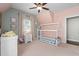 Comfortable bedroom with neutral tones, large windows, and a unique house frame bed at 1810 Annie Nw St, Atlanta, GA 30318