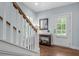 Inviting foyer with hardwood floors, white staircase, and a view of the front door at 1810 Annie Nw St, Atlanta, GA 30318