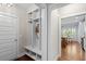 Hallway with storage and an adjacent kitchen dining area, filled with natural light at 1810 Annie Nw St, Atlanta, GA 30318