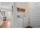 Convenient laundry room with modern washer and dryer units and wooden storage at 1810 Annie Nw St, Atlanta, GA 30318