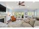 Cozy living room with blue walls, a ceiling fan, fireplace, and a view of the outdoor patio at 1810 Annie Nw St, Atlanta, GA 30318