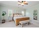 Charming main bedroom with bench, side table and ceiling fan at 1810 Annie Nw St, Atlanta, GA 30318