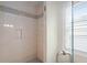 Close up of tiled shower stall with glass door and neutral color scheme at 1810 Annie Nw St, Atlanta, GA 30318