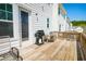 Outdoor wooden deck features outdoor seating, grill and white siding on the back of the home at 458 Bishop Ln, Woodstock, GA 30188
