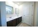 Bright bathroom featuring a double sink vanity and a shower with glass doors at 458 Bishop Ln, Woodstock, GA 30188