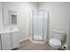 Bathroom boasts modern vanity, toilet, and glass-enclosed shower at 458 Bishop Ln, Woodstock, GA 30188