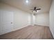 Bedroom with laminate flooring, bright ceiling fan, and closet doors at 458 Bishop Ln, Woodstock, GA 30188