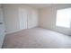 A spacious bedroom featuring neutral walls, plush carpeting, and a window with blinds at 458 Bishop Ln, Woodstock, GA 30188