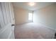 Neutral bedroom with plush carpeting and a window with blinds for a clean, minimalist aesthetic at 458 Bishop Ln, Woodstock, GA 30188
