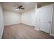 Bedroom with laminate floors, ceiling fan, and multiple bright white doors at 458 Bishop Ln, Woodstock, GA 30188
