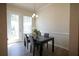 Dining area features a table with seating for four, natural light, and hardwood style flooring at 458 Bishop Ln, Woodstock, GA 30188