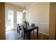 Dining area features a table with seating for four, natural light, and hardwood style flooring at 458 Bishop Ln, Woodstock, GA 30188