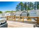 Back deck view of new construction homes with garages, trees, and blue sky at 458 Bishop Ln, Woodstock, GA 30188