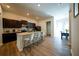 Open kitchen features dark cabinets, stainless steel appliances, and a large kitchen island with seating at 458 Bishop Ln, Woodstock, GA 30188