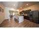 Modern kitchen boasts stainless appliances, dark cabinets, island with breakfast bar, and wood floors at 458 Bishop Ln, Woodstock, GA 30188