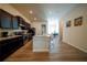 Spacious kitchen features dark cabinets, stainless steel appliances, and a large kitchen island at 458 Bishop Ln, Woodstock, GA 30188