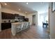Open-concept kitchen featuring a breakfast bar, dark wood cabinets, and stainless steel appliances at 458 Bishop Ln, Woodstock, GA 30188