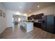 Modern kitchen with island, stainless steel appliances, and dark cabinets, flowing into living space at 458 Bishop Ln, Woodstock, GA 30188