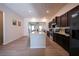 Bright kitchen features granite island with seating, dark cabinets, stainless appliances, and hardwood floors at 458 Bishop Ln, Woodstock, GA 30188