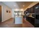 Bright kitchen features granite island with seating, dark cabinets, stainless appliances, and hardwood floors at 458 Bishop Ln, Woodstock, GA 30188