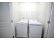 A clean laundry room featuring a white washer and dryer set and a wire rack shelf above at 458 Bishop Ln, Woodstock, GA 30188