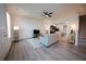 Open-concept living room with hardwood floors and a ceiling fan adjacent to the kitchen at 458 Bishop Ln, Woodstock, GA 30188
