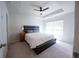Bright main bedroom with a tray ceiling, ceiling fan, carpet floors and a large window for natural light at 458 Bishop Ln, Woodstock, GA 30188