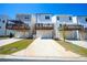Rear of modern townhomes with garages and elevated wood decks at 458 Bishop Ln, Woodstock, GA 30188