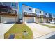 Rear view of modern townhomes with garage parking and wooden decks at 458 Bishop Ln, Woodstock, GA 30188