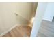 Carpeted staircase descending, with a white handrail and grey laminate flooring at 458 Bishop Ln, Woodstock, GA 30188